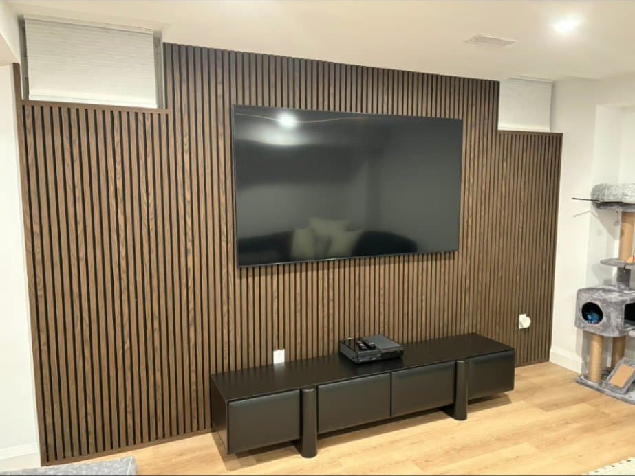 Custom wood slat accent wall with built-in media console